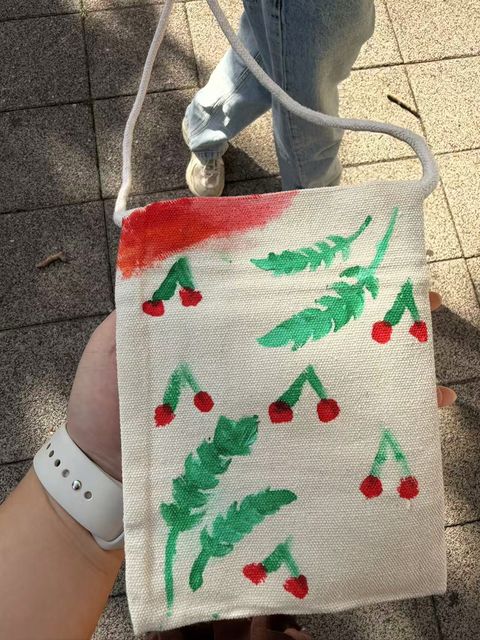A handmade bag with green leaves and red berries