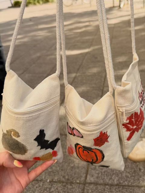 Friends showing their finished Halloween bags