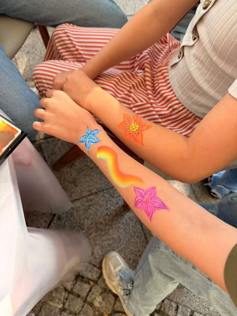 Rainbow and flower arm art at the workshop