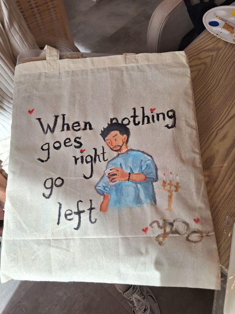 A finished tote bag with a character and handwritten quote
