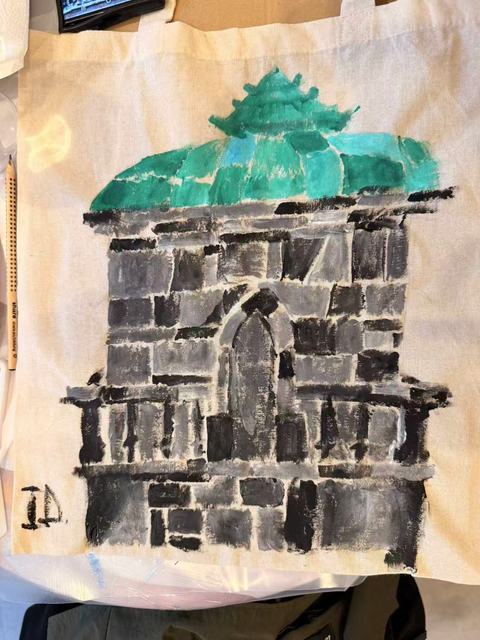 Tote bag painted with a grey stone pavilion and a green copper roof