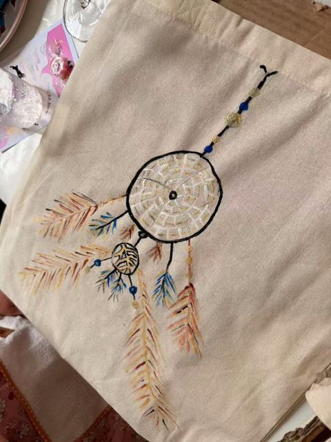 Tote bag painted with a dreamcatcher and feathers